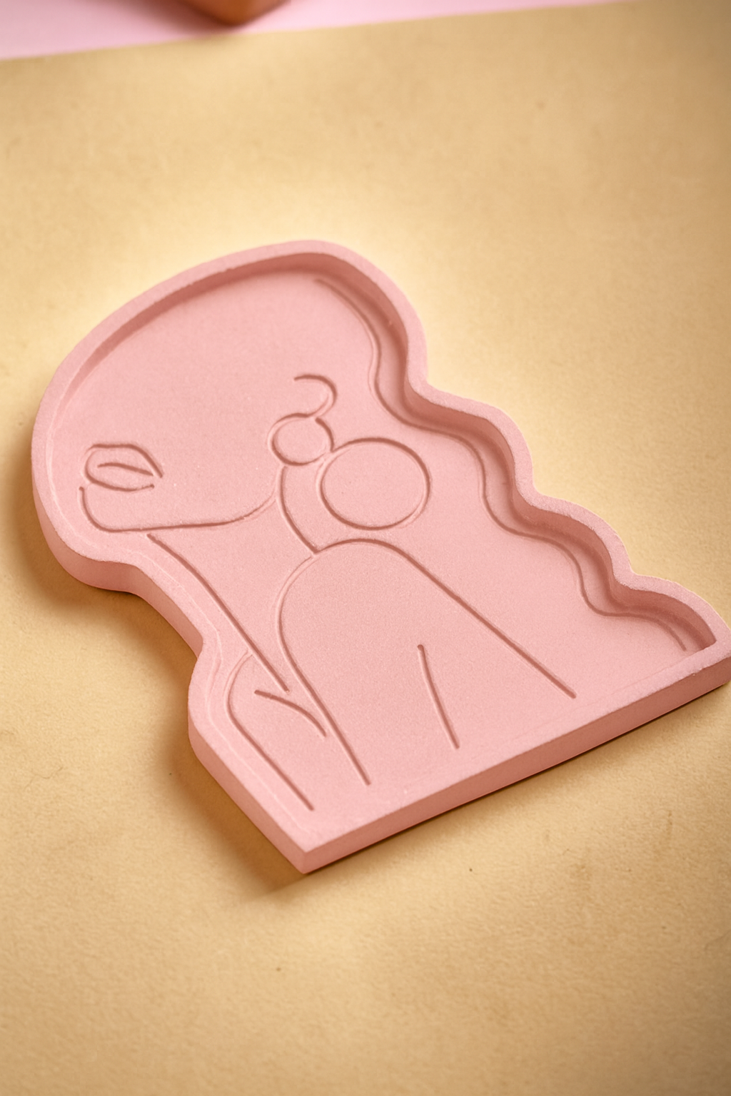 Beauty Candle Tray Pink: A pink decorative tray for candles, shaped like a woman's silhouette with minimalist line art details, perfect for holding sculpted or small candles.