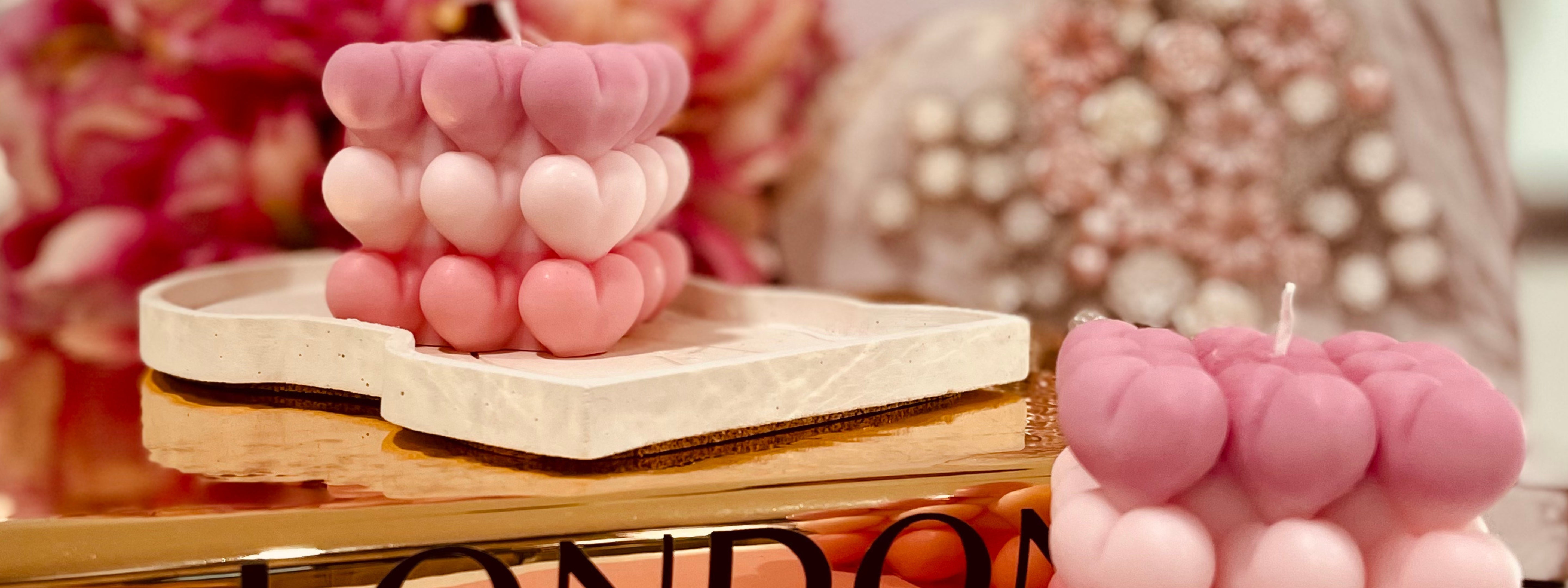Pink heart-shaped sculptural candles displayed on a marble tray, styled as a romantic Valentine’s Day décor piece by Dahil Bar.