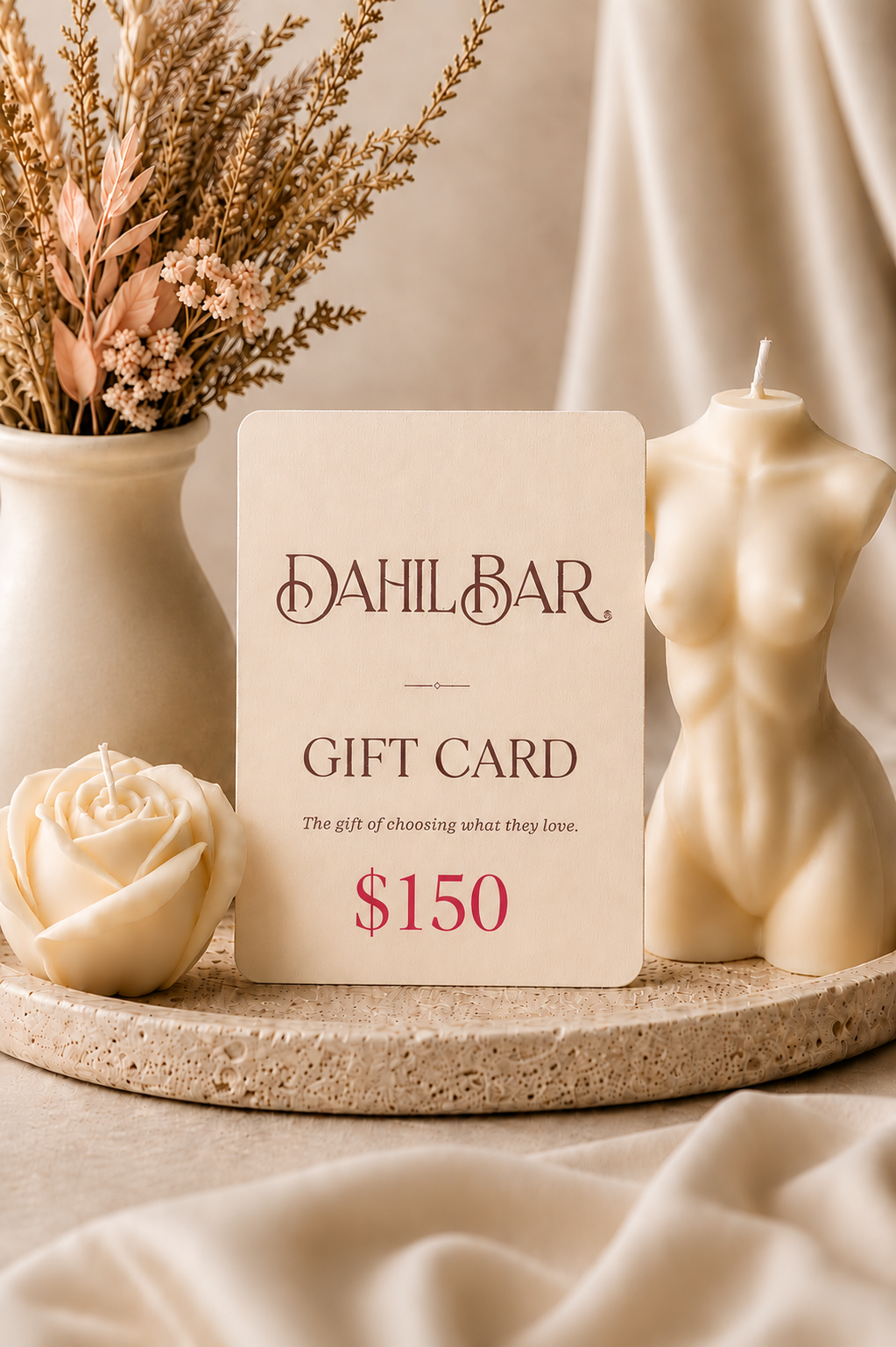 Dahil Bar $150 digital gift card displayed with an ivory rose candle and sculptural body candle in a warm, neutral luxury setting.