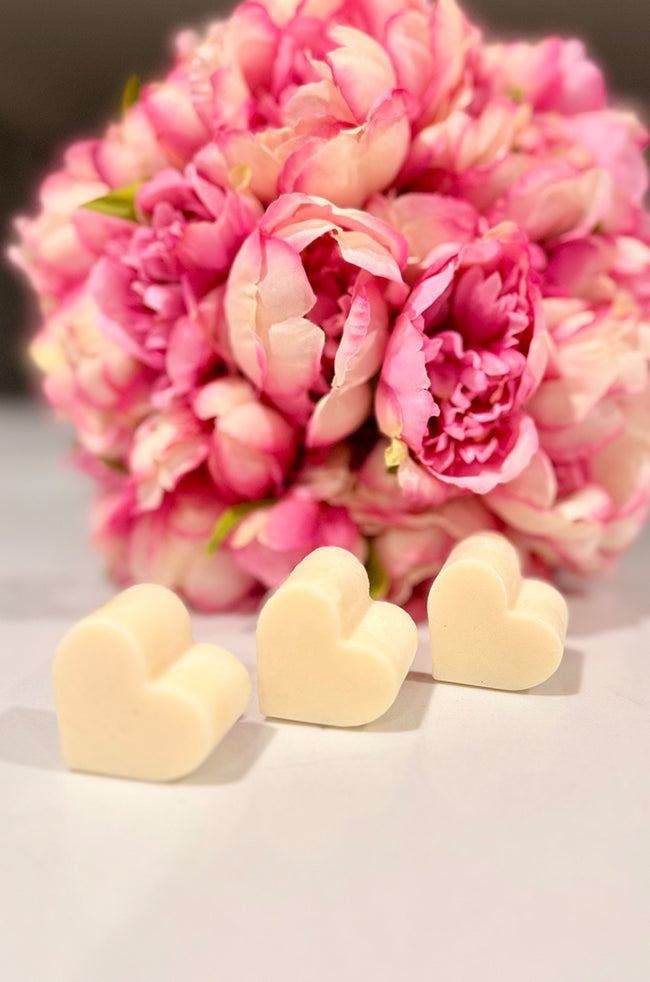 Heart Wax Melts: Three Heart Wax Melts displayed on a neutral surface with pink floral décor