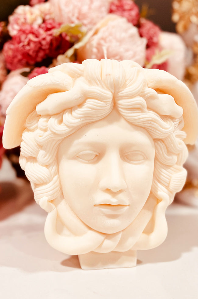 Medusa Candle: Side view of the Medusa candle showing the layered texture of the serpents winding through the hair and the candle’s sculptural depth.