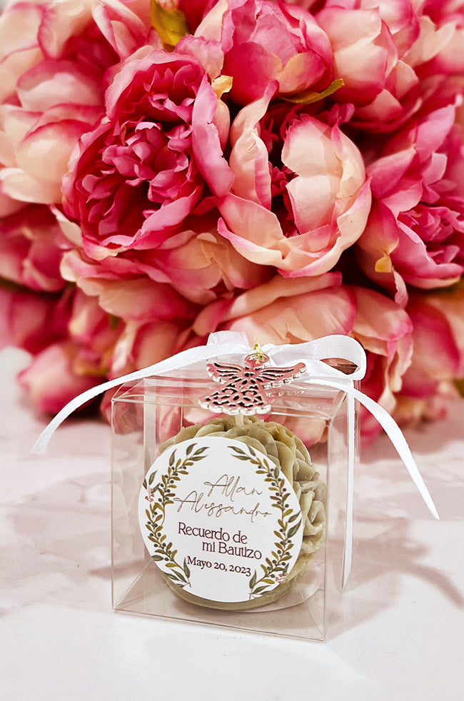 Mini Bloom Gifted Candle: Mini Bloom candle favor with white ribbon and angel charm for baptism gift.