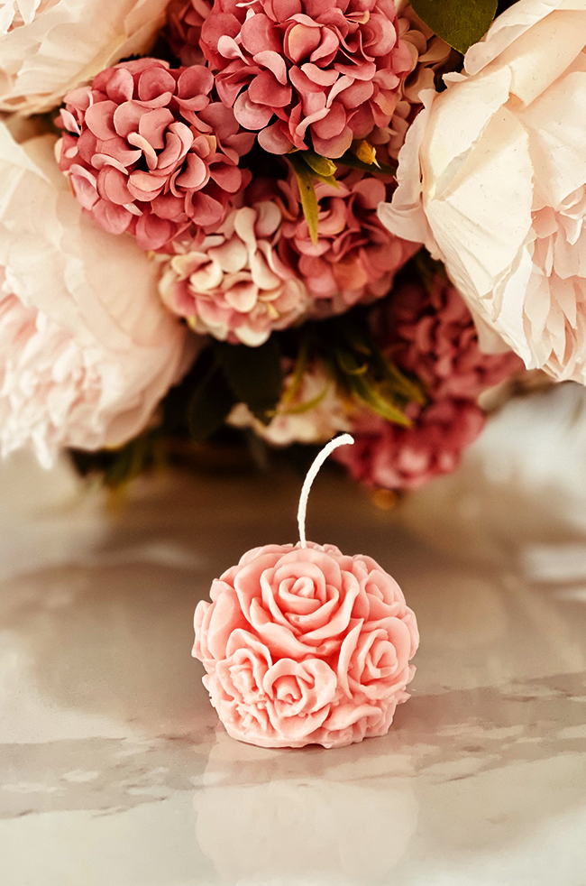 Mini Bloom Candle: Pink rose-inspired Mini Bloom candle styled with soft floral decor.