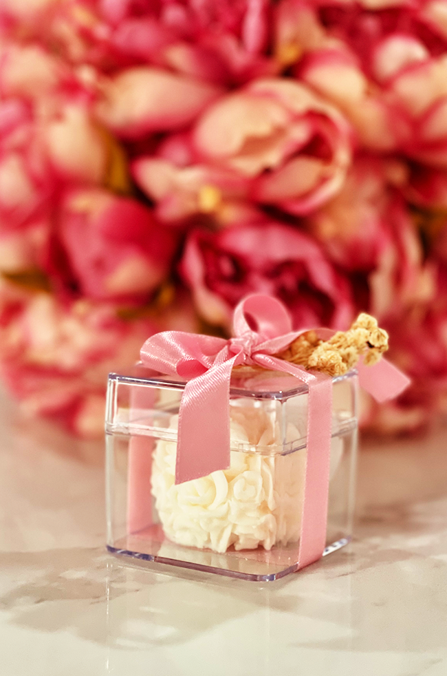 Mini Bloom Gifted Candle: Mini Bloom candle in clear favor box tied with a pink satin ribbon.
