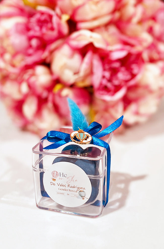 Mini Bubble Candle: Blue Mini Bubble candle favor in a clear box with navy ribbon, feather accent, and crown charm for gender reveal.