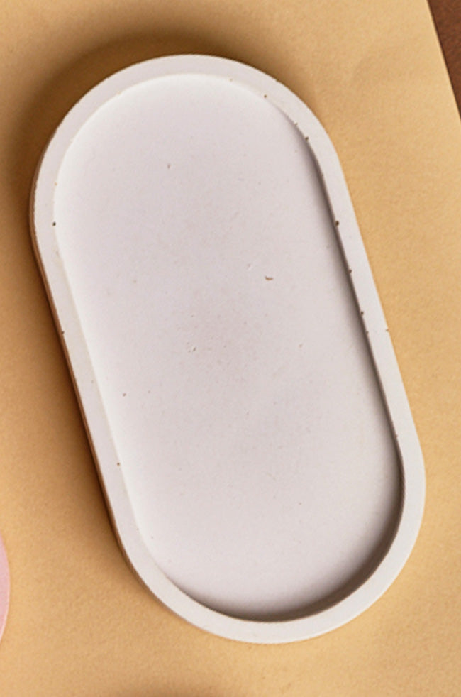 Oval Tray: Close-up of a white oval tray with a smooth matte finish, designed for modern minimalist home styling.