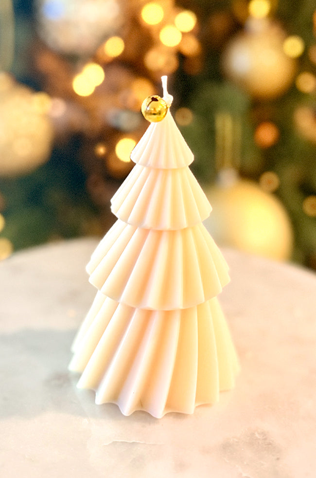 Solstice Tree Large Candle: Minimalist cream-colored tree candle adorned with gold foil and a gold bell topper, perfect for luxury holiday décor.
