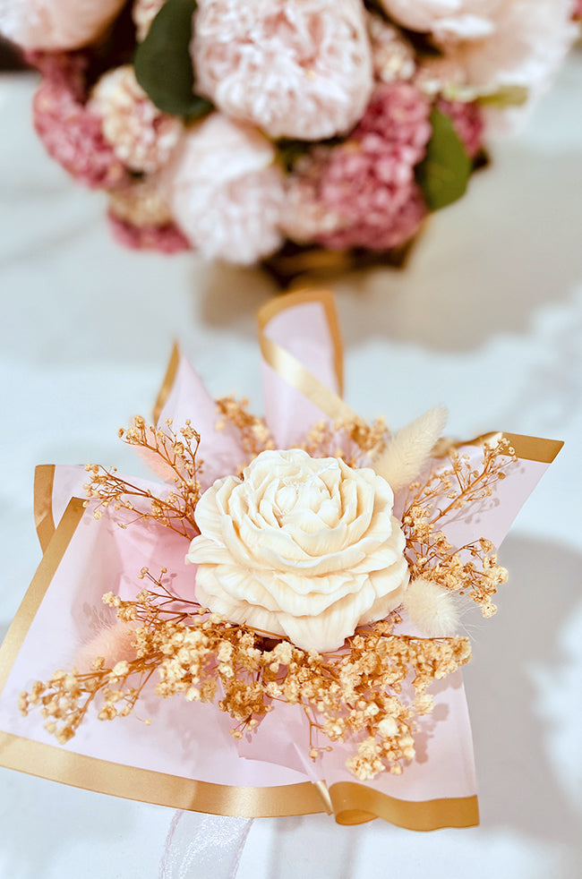 Peony Bliss Bouquet Candle: Top view of Peony Bliss candle bouquet showcasing sculpted wax peony surrounded by dried flowers and elegant wrapping.