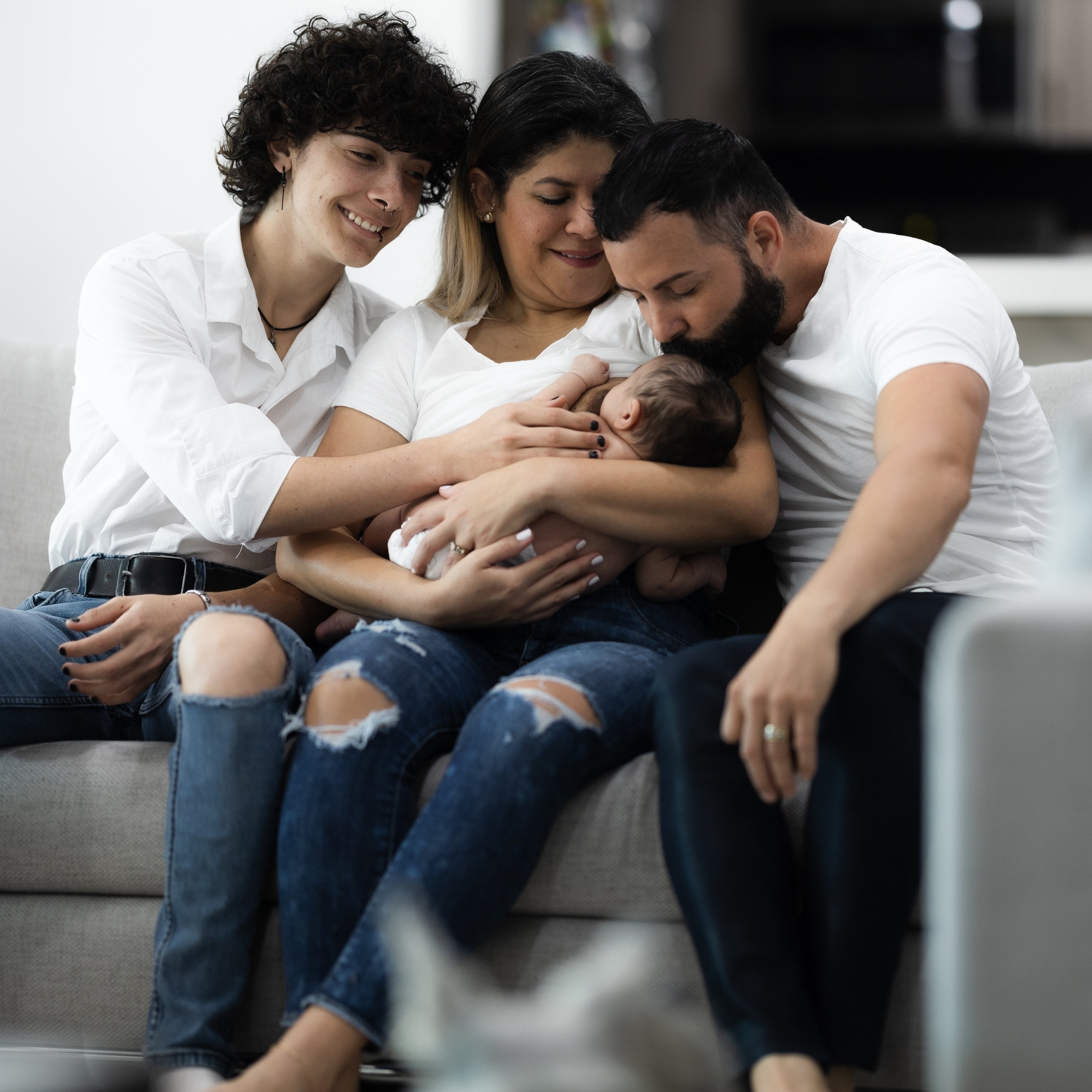 Dahil Bar founder seated with her husband, stepson, and newborn daughter in a warm family portrait at home.