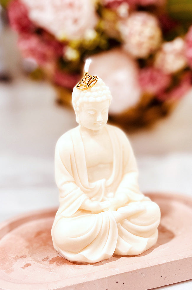 Dhyana Mudra Buddha: Hand-poured Dhyana Mudra Buddha candle with lotus charm, ivory wax sculpture on a pink tray—luxury handmade home décor accent.