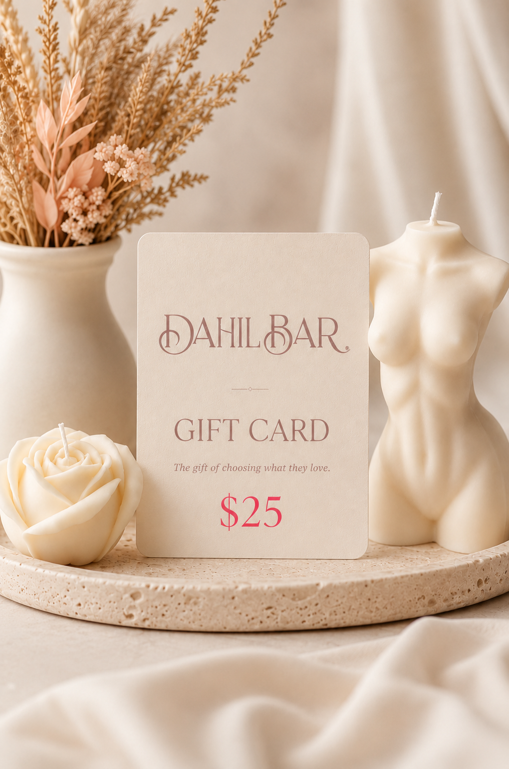 Dahil Bar $25 digital gift card displayed with ivory rose and sculptural body candles in a warm, neutral luxury setting.