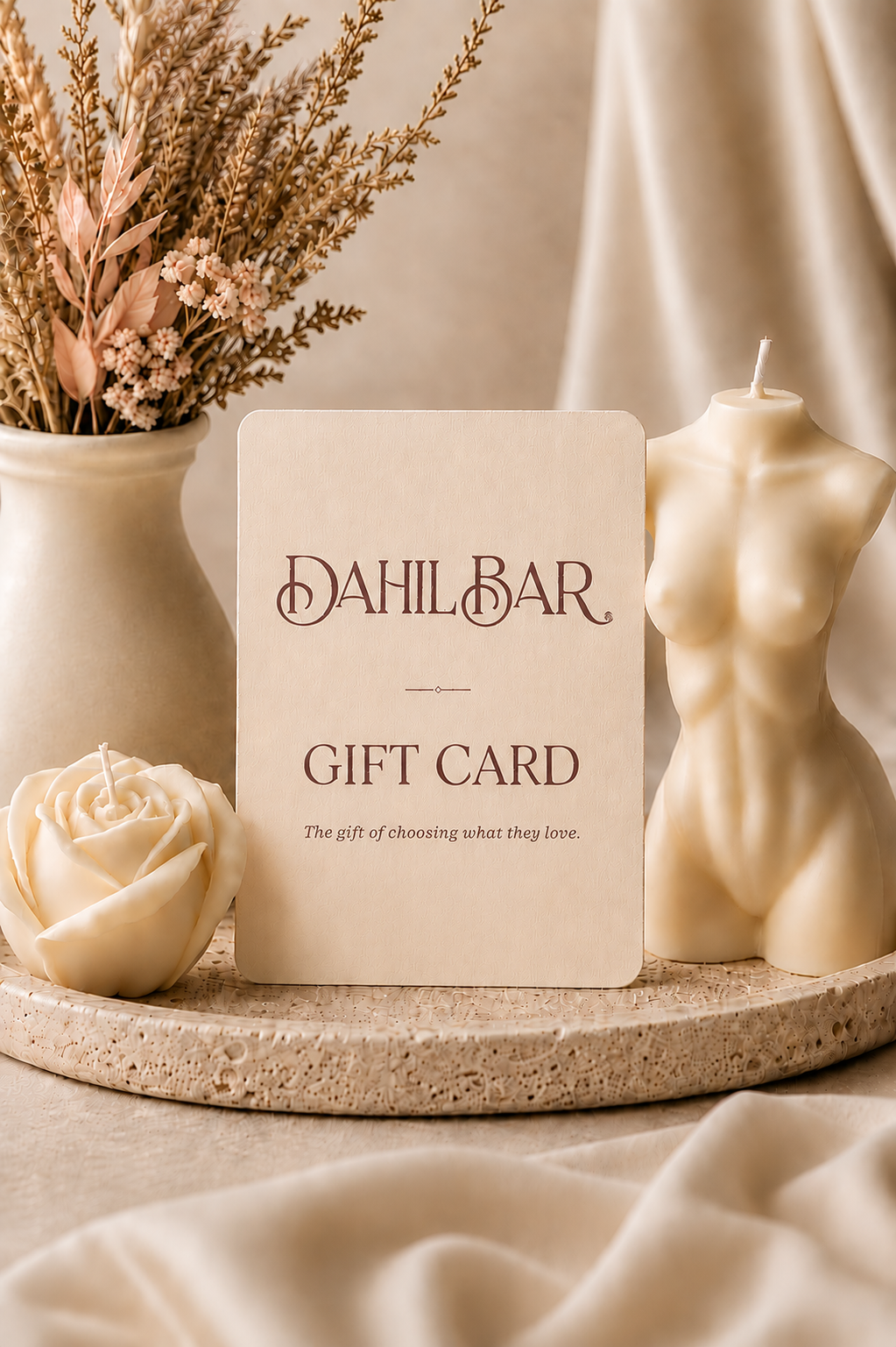 Dahil Bar digital gift card displayed with an ivory rose candle and sculptural body candle in a warm, neutral luxury setting.
