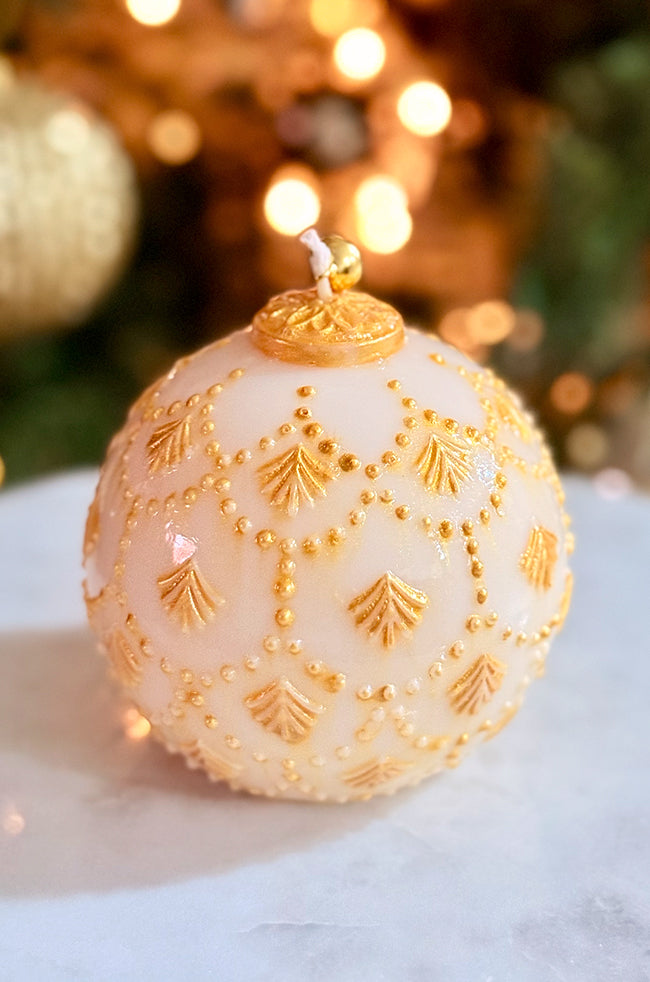 Golden Star Ornament Candle: Refined holiday candle designed to look like a luxe ornament, featuring gold hand-painted accents and a golden bell on top.