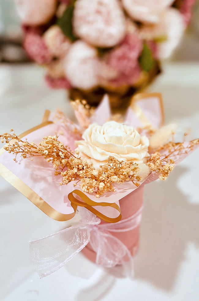 Peony Bliss Bouquet Candle: Peony Bliss candle arranged as a luxury candle flower bouquet with blush wrapping, dried florals, and satin ribbon.