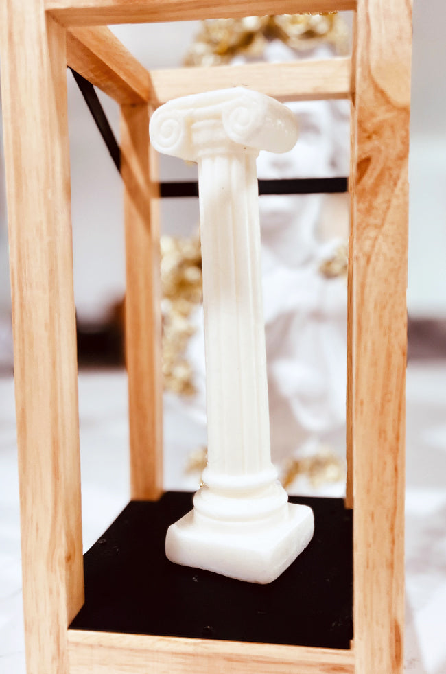 Pillar of Light Candle: Handmade Pillar of Light sculptural candle inspired by a classical column, displayed as minimalist decor in a wooden frame