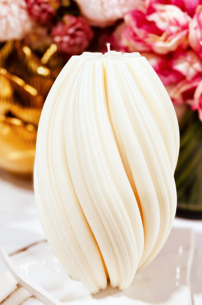Rising Column Large Candle: Close-up of the ivory Rising Column Large sculptural candle with textured twisting curves.