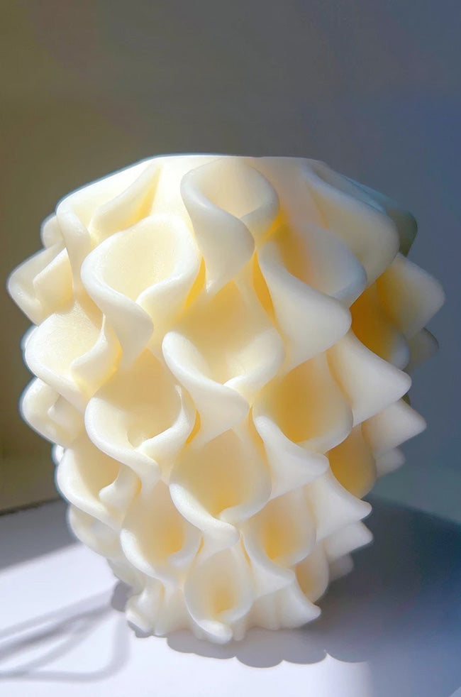 Shining Lilies Candle: Ivory Shining Lilies sculptural candle with layered lily-inspired petals and soft natural lighting.