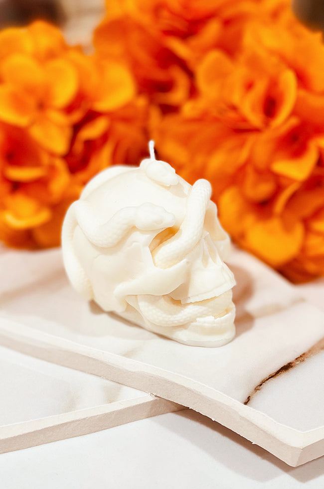 Skull Snake Candle: Side view of the ivory Skull Snake Halloween candle showing the snake curling around the skull.