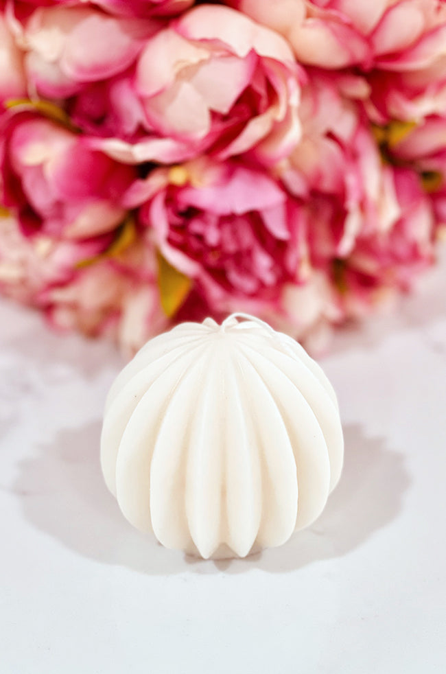 The Oval Light Candle: Handmade sculptural oval candle with grooved design, The Oval Light, styled for luxury minimalist home décor.